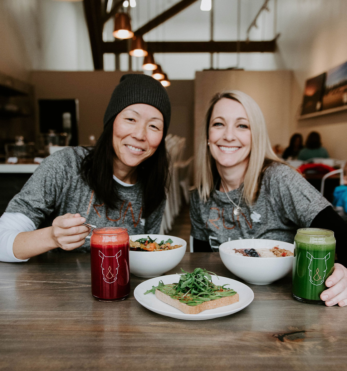 Fix & Repeat owners, Leila and Kristin, enjoying a cold-pressed juice and plant-based meal at the restuarant
